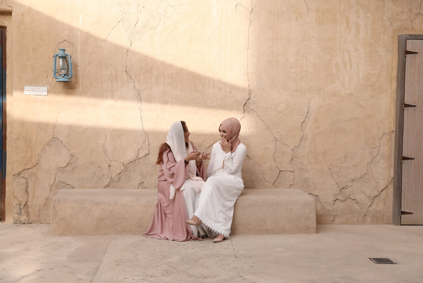 Couple walking together and holding hands in the desert sands of Al Qudra Lake