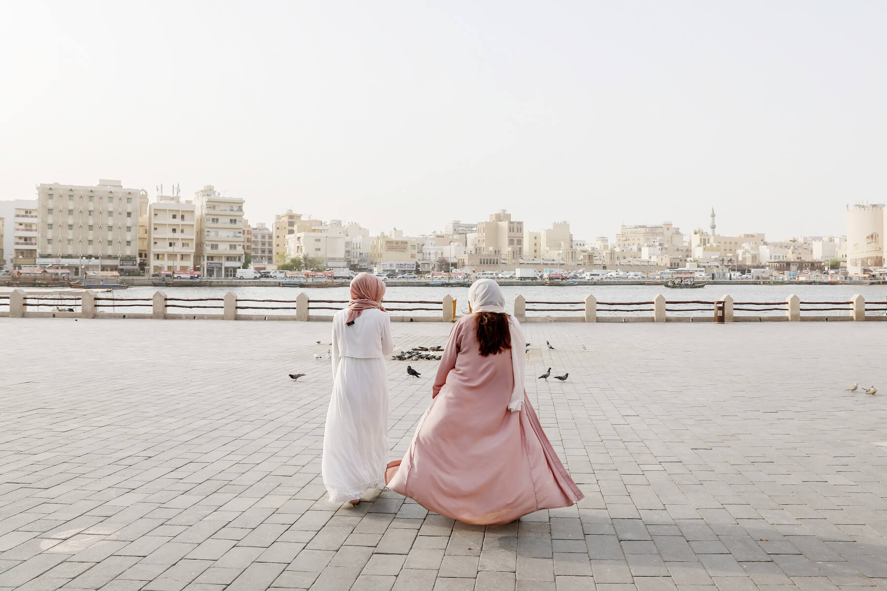 Couple walking together and holding hands in the desert sands of Al Qudra Lake