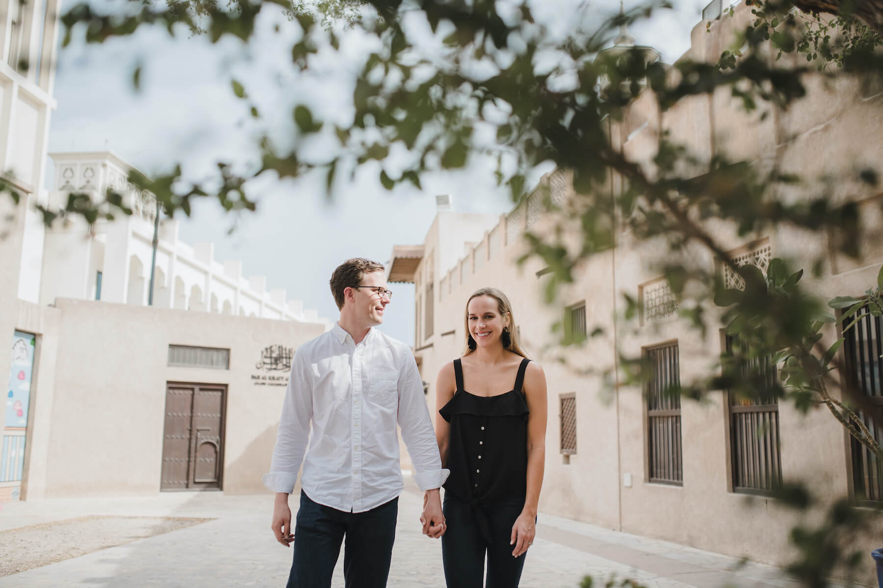 Couple holding hands and walking down alleyway in Old Dubai, Dubai United Arab Emirates