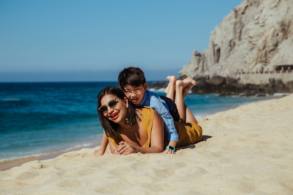 Mom and son smiling on the beach in Cabo san Lucas