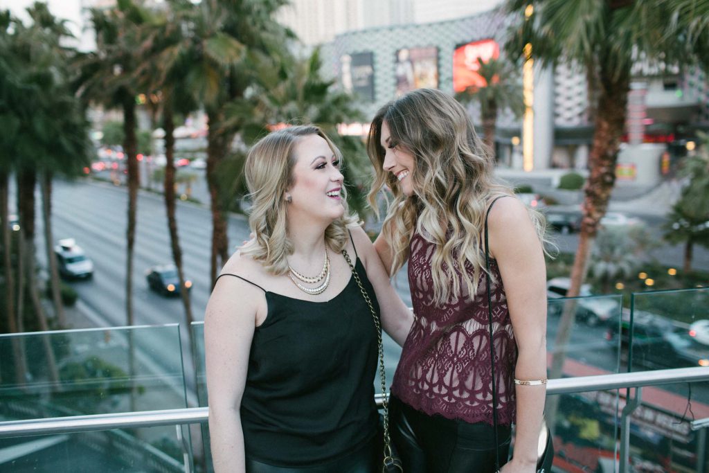 Two girlfriends smiling at each other in Las Vegas
