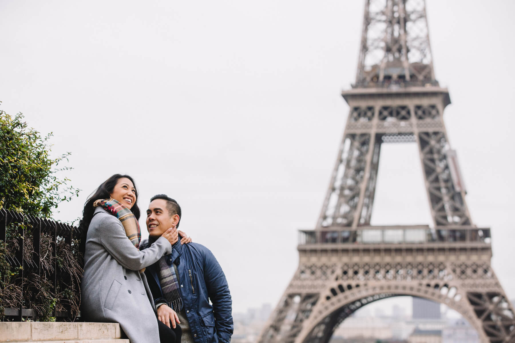 Close up portrait of a couple wearing patterned wool scarves in Paris, France