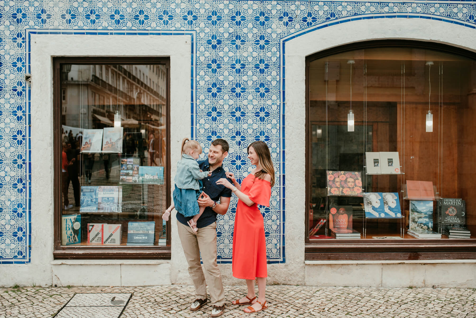 a family standing in front of book store in Lisbon, Portugal