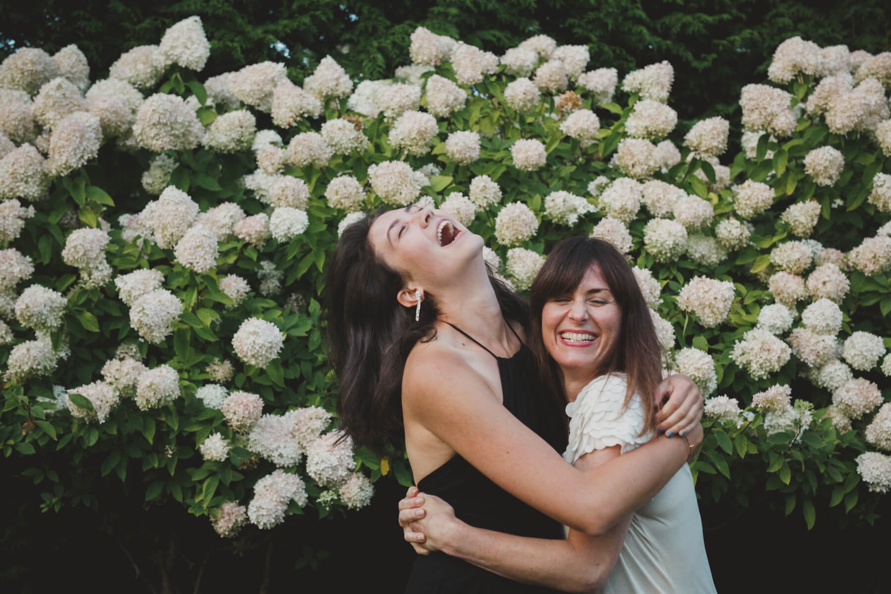 two girls hugging and having fun at the office garden party