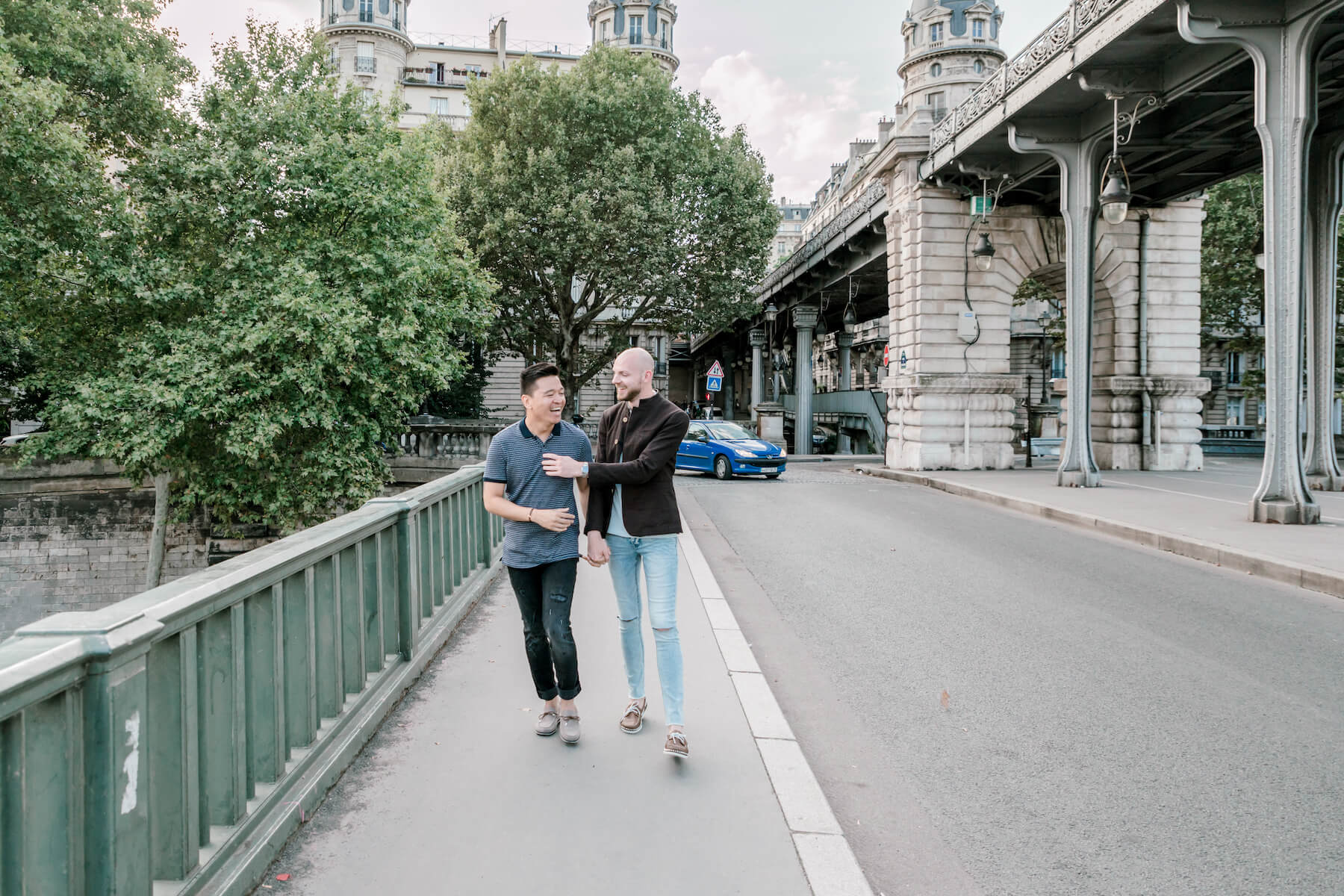 a couple walking near the Eiffel tower in Paris, France