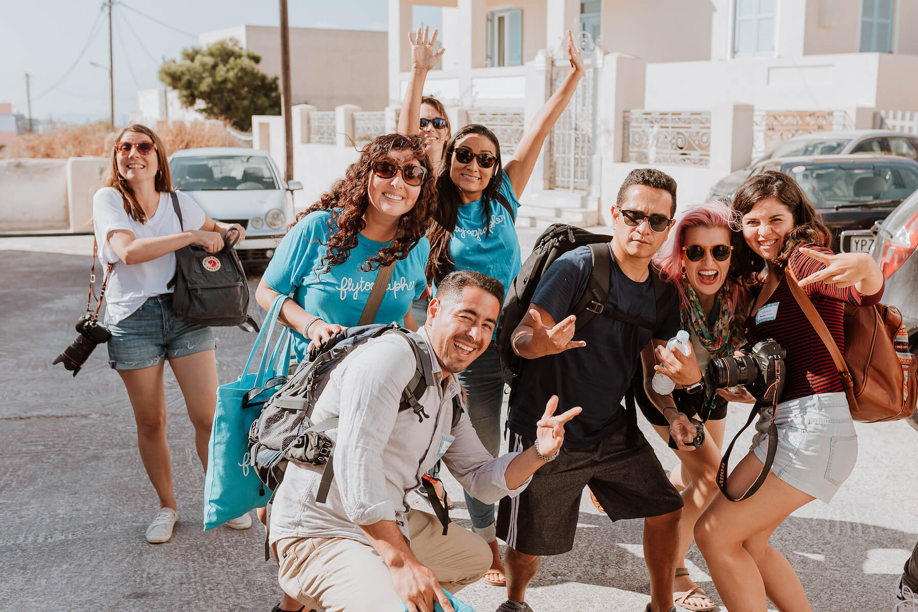 Group of photographers smiling at camera in Santorini, Greece.