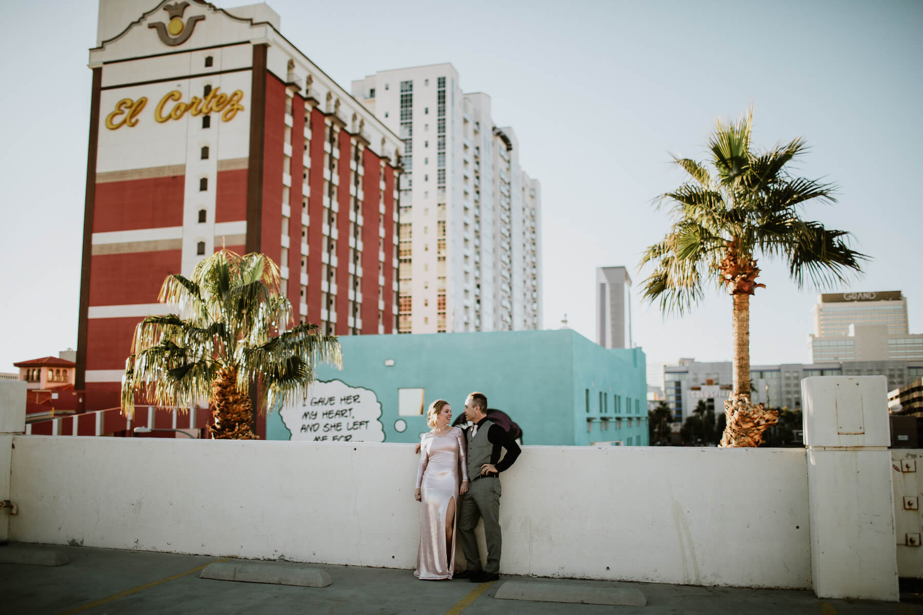 A couple dressed up are hugging in Las Vegas on a couple shoot with Flytographer to celebrate their wedding.