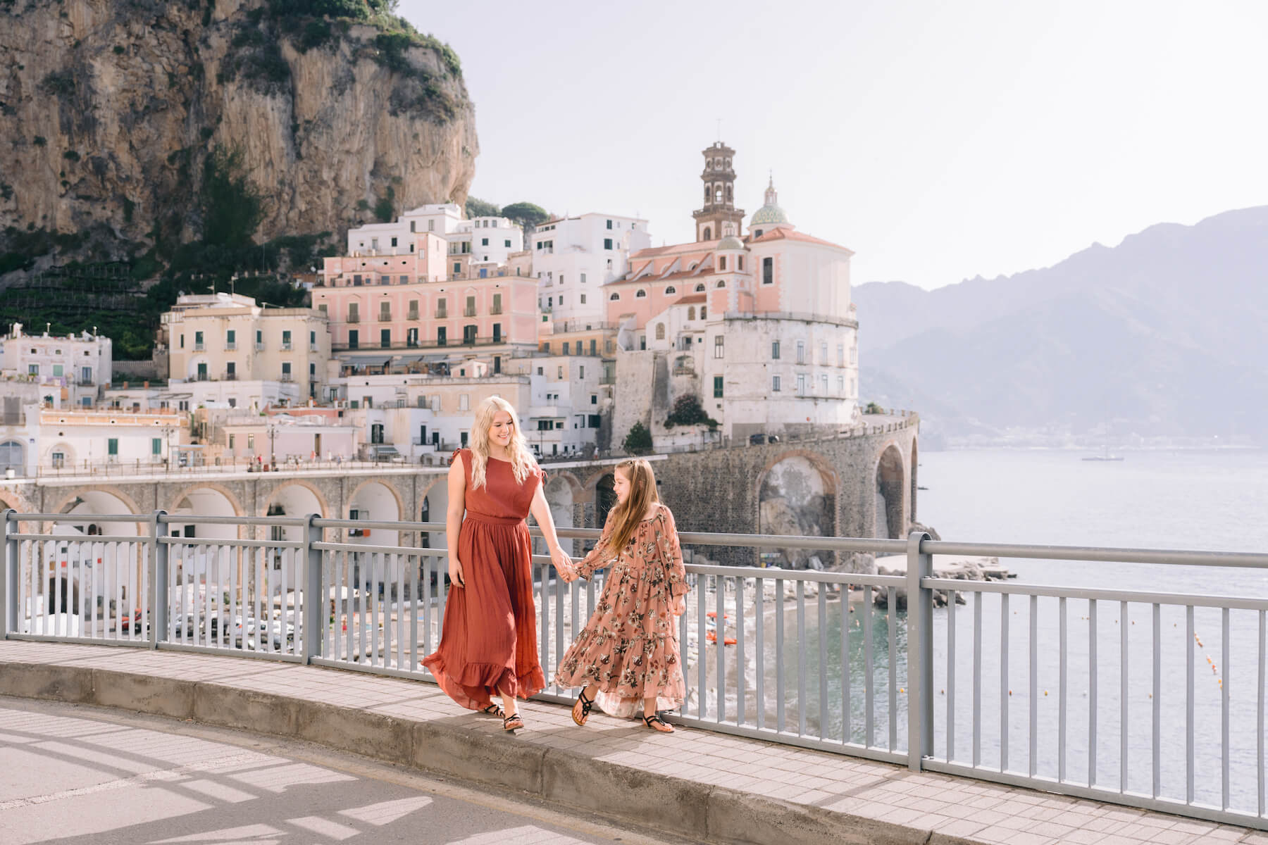 Mother and daughter walking in Italy